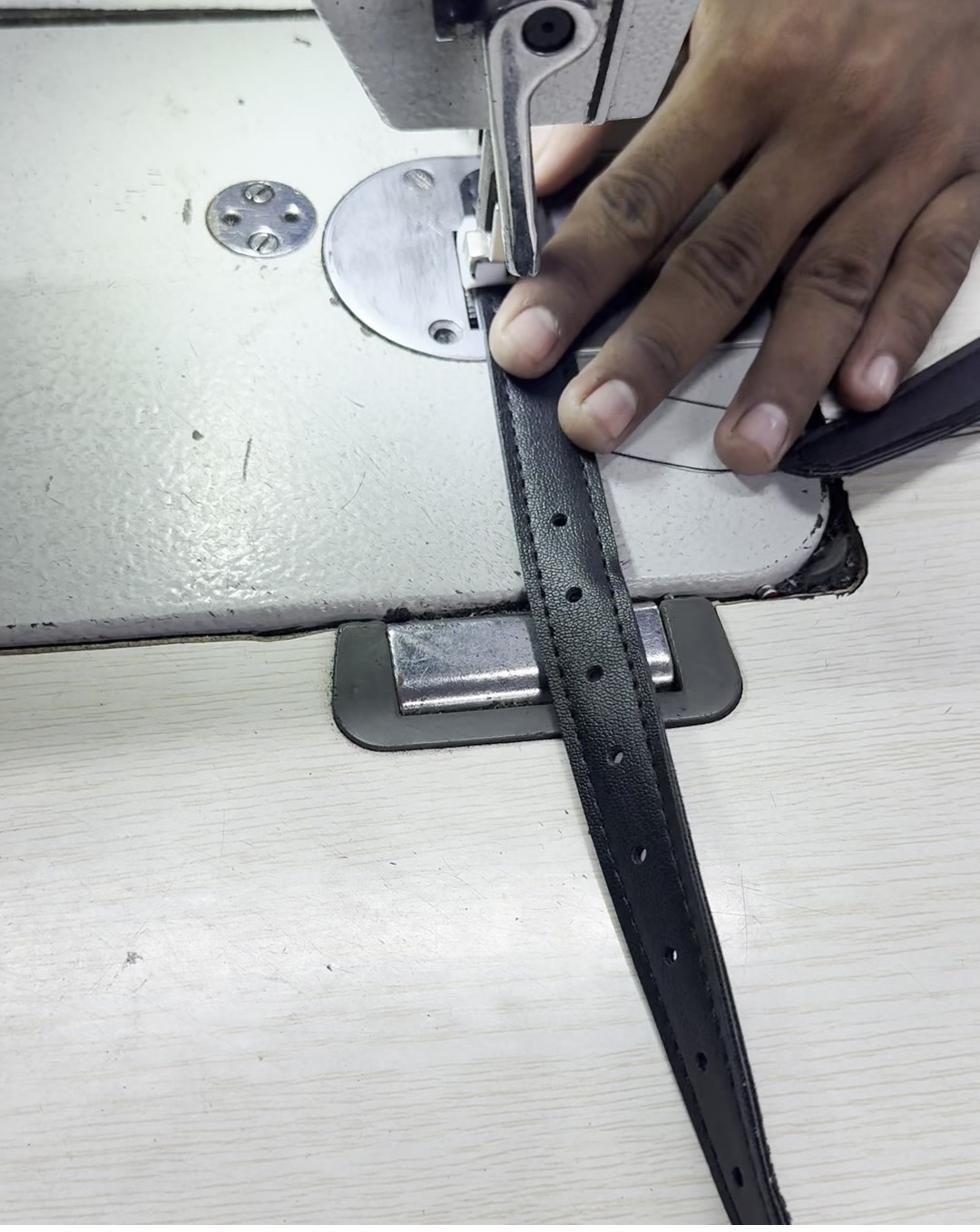 Leather strap being stitched on an industrial sewing machine